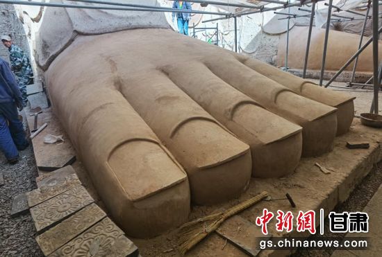 圖為中國“石窟鼻祖”天梯山石窟第13窟大佛足部與局部危巖體搶救性保護項目施工現(xiàn)場。陳曉斌 攝
